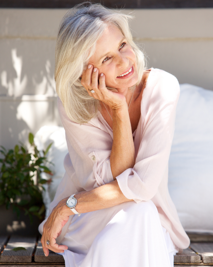 Happy older woman smiling naturally, representing confidence and balanced perspectives on wrinkles and ageing.